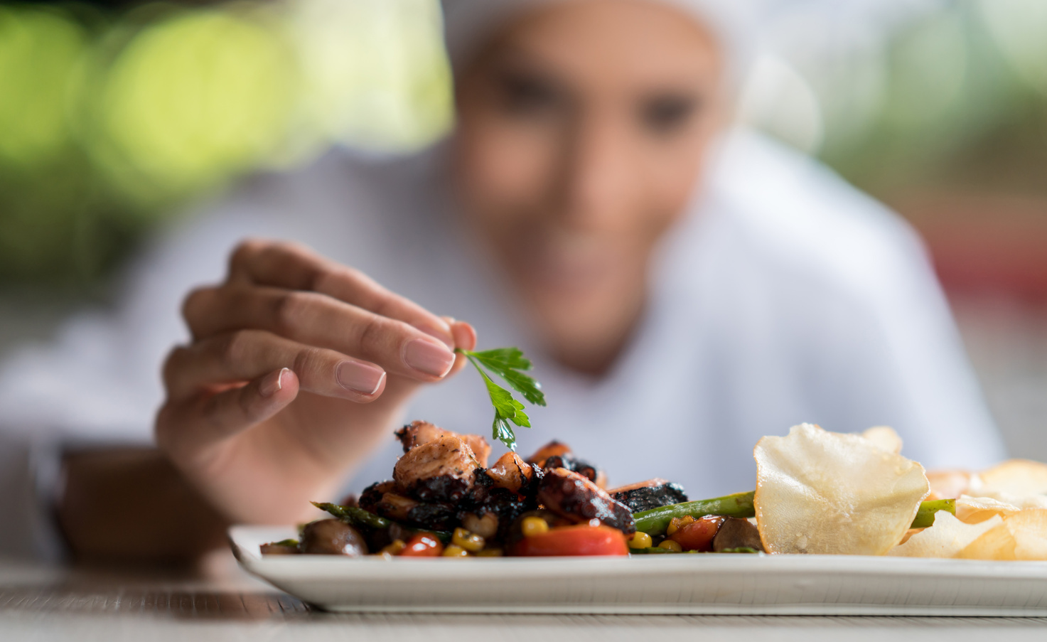 Chef decorating a plate